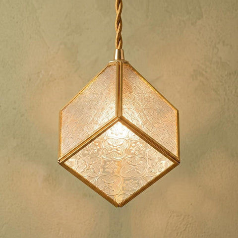 Clear faceted cube pendant with a gold-tone frame and pendant cord
