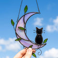 Black Cat Window Hanging on Purple Crescent Moon with Green Leaves by AuroraeGlass — photo 1