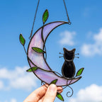 Black Cat Window Hanging on Purple Crescent Moon with Green Leaves by AuroraeGlass — photo 1